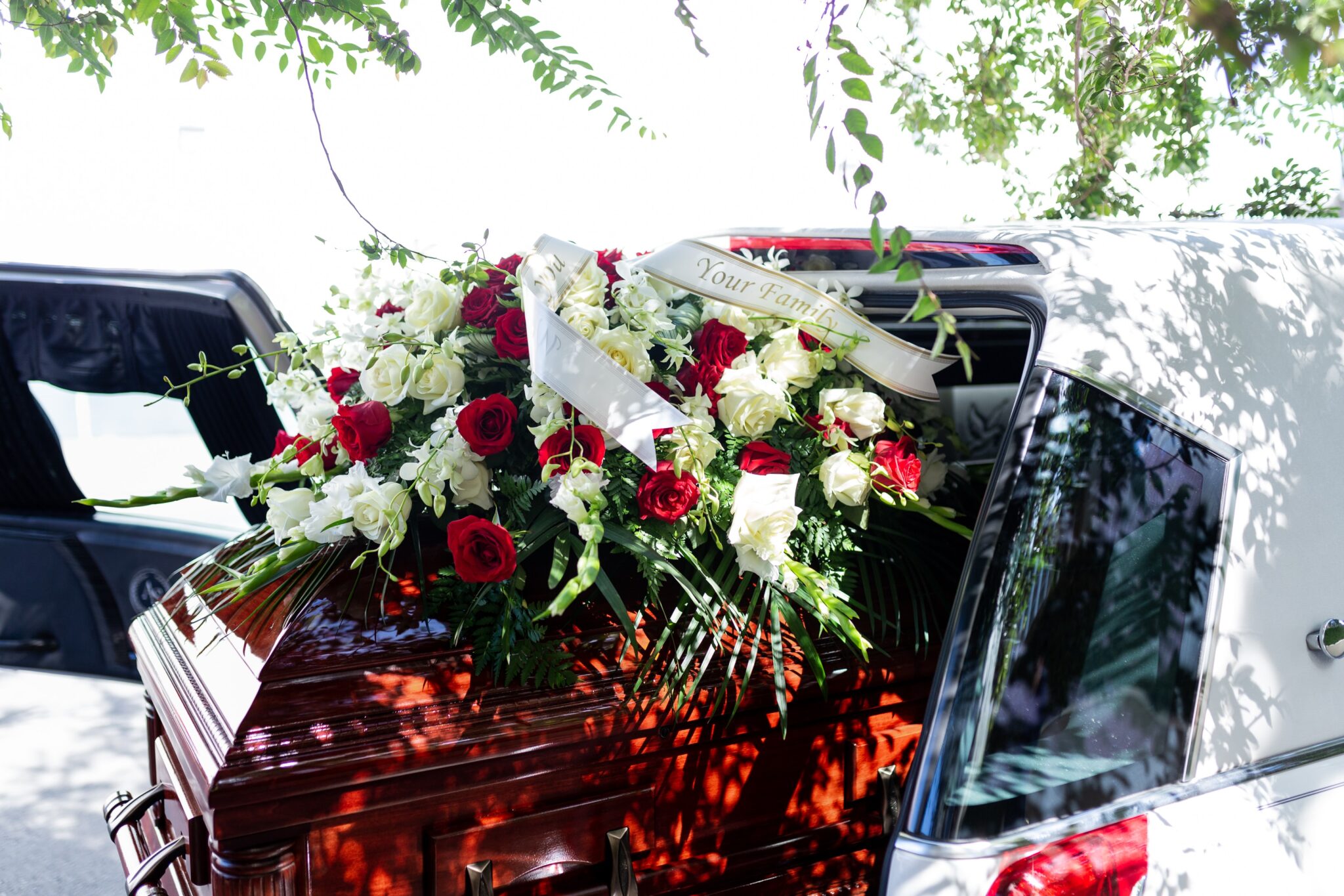 Picture of coffin with flowers inside a car