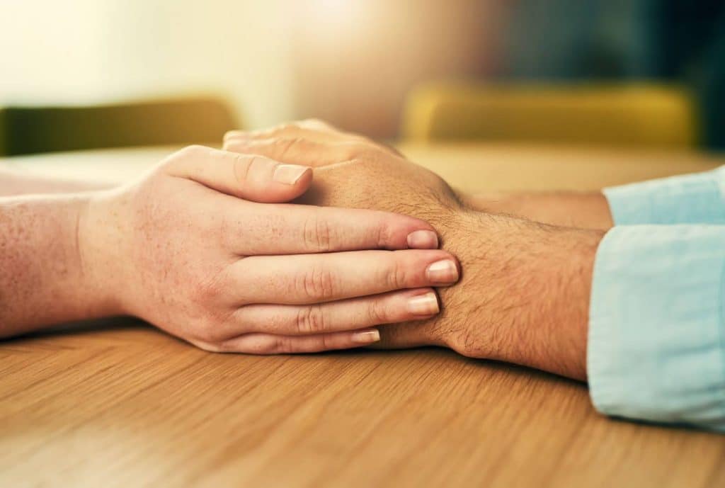 supportive hands on table