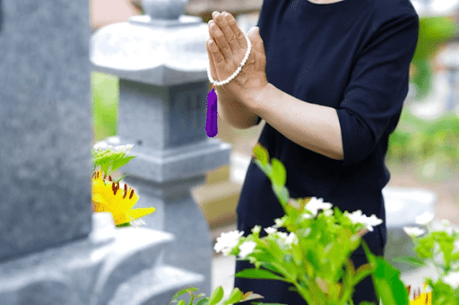 paying respect to the tombstone of the deceased