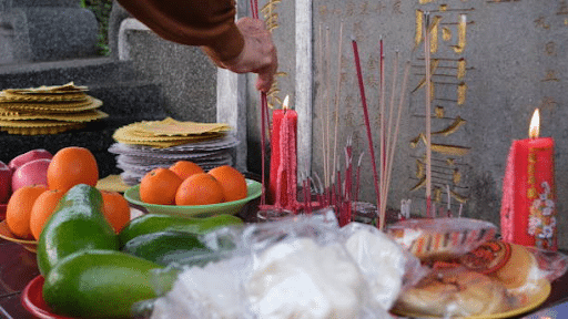 ancestral tomb with food and joss stick offering