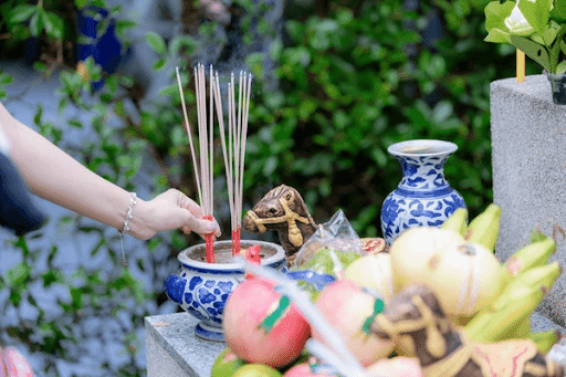 placing incense sticks as offering