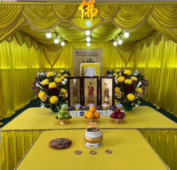 Buddhist Funeral Services Singapore - Gold themed Buddhist funeral with fruits and offerings on the altar