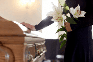 farewell with flower and hand on coffin
